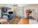 A cozy living room with hardwood floors and a large window at 5501 67Th N Ave # 11, Pinellas Park, FL 33781