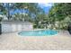 Sparkling outdoor pool surrounded by brick patio and lush greenery, perfect for recreation at 5501 67Th N Ave # 11, Pinellas Park, FL 33781