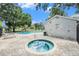Community pool and hot tub surrounded by brick pavers, offering a luxurious outdoor experience at 5501 67Th N Ave # 11, Pinellas Park, FL 33781