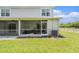 Back of home featuring a screened-in porch and green lawn, perfect for relaxing outdoors at 5501 67Th N Ave # 11, Pinellas Park, FL 33781