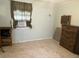 Simple bedroom featuring tile floors, a window with curtains, and room for essential furnishings at 5807 N Hale Ave, Tampa, FL 33614