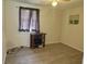 Neutral bedroom with window, wood-look flooring, basic ceiling fan, and simple decor at 5807 N Hale Ave, Tampa, FL 33614