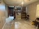 Bright living room featuring tile floors and a partial divider wall to the kitchen at 5807 N Hale Ave, Tampa, FL 33614