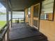 Exterior porch featuring rocking chairs, table and chairs, with view into yard at 5807 N Hale Ave, Tampa, FL 33614
