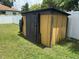 Exterior shed with partial door in fenced yard at 5807 N Hale Ave, Tampa, FL 33614
