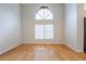 Large bedroom with hardwood floors, a tall window and plenty of natural light at 6123 India Dr, Spring Hill, FL 34608