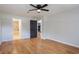 Spacious bedroom features a ceiling fan, hardwood floors and neutral color palette, offering a bright and airy feel at 6123 India Dr, Spring Hill, FL 34608