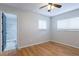 Bright bedroom boasts gleaming hardwood floors, a ceiling fan and natural light, crafting a comfortable and inviting space at 6123 India Dr, Spring Hill, FL 34608