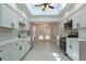 Well-lit kitchen featuring white cabinets, stainless steel appliances, and skylight at 6123 India Dr, Spring Hill, FL 34608