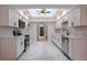Modern kitchen with white cabinets, stainless steel appliances and ample counter space at 6123 India Dr, Spring Hill, FL 34608