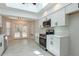 Cozy kitchen with white cabinets, stainless steel appliances, and double doors to the backyard at 6123 India Dr, Spring Hill, FL 34608