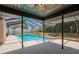 A refreshing in-ground pool is surrounded by a screened-in enclosure and plenty of patio space to enjoy at 6123 India Dr, Spring Hill, FL 34608