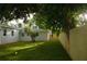 Spacious backyard with a new fence, lush green grass, and mature trees offering ample shade at 6332 Emerson S Ave, St Petersburg, FL 33707
