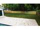 Large, fenced backyard with a stone patio offering privacy and ample space for outdoor activities at 6332 Emerson S Ave, St Petersburg, FL 33707