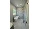 Luxurious bathroom featuring a freestanding tub, marble tiling, a window, and a golden shower head at 6332 Emerson S Ave, St Petersburg, FL 33707