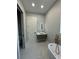 Stylish bathroom featuring a modern vanity, freestanding tub, and sleek fixtures under recessed lighting at 6332 Emerson S Ave, St Petersburg, FL 33707