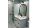Charming powder room featuring a marble vanity, elegant mirror, and modern toilet at 6332 Emerson S Ave, St Petersburg, FL 33707