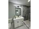 Modern bathroom with new light fixture, white vanity and marble shower at 6332 Emerson S Ave, St Petersburg, FL 33707