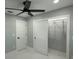 Contemporary bedroom featuring a ceiling fan, closet with sliding doors, and minimalist design at 6332 Emerson S Ave, St Petersburg, FL 33707
