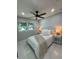 Bright bedroom featuring a ceiling fan, neutral walls, and a window that brings natural light in the room at 6332 Emerson S Ave, St Petersburg, FL 33707