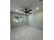 Clean and spacious bedroom featuring neutral walls, bright floors, and a window overlooking the neighborhood at 6332 Emerson S Ave, St Petersburg, FL 33707