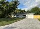 Well-manicured home with an attached garage, updated driveway and green lawn at 6332 Emerson S Ave, St Petersburg, FL 33707
