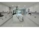 Bright, white kitchen with a large island, stainless steel appliances, and white herringbone backsplash at 6332 Emerson S Ave, St Petersburg, FL 33707