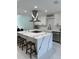 A bright kitchen showcases a waterfall island, stainless steel hood, and herringbone backsplash at 6332 Emerson S Ave, St Petersburg, FL 33707