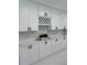 Modern kitchen with white cabinets, marble counter tops, tiled backsplash, and great storage space at 6332 Emerson S Ave, St Petersburg, FL 33707