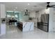 Modern, open kitchen boasts a large island, stainless steel appliances, and sleek white cabinetry at 6332 Emerson S Ave, St Petersburg, FL 33707