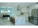 Modern white kitchen features a large island with a marble countertop and stainless steel appliances at 6332 Emerson S Ave, St Petersburg, FL 33707