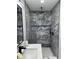 Modern bathroom features a marble shower with black fixtures, and built in niche at 6332 Emerson S Ave, St Petersburg, FL 33707