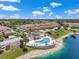 Aerial view showcases a community pool, cabana, and lakeside living at 6400 46Th N Ave # 61, Kenneth City, FL 33709