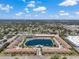 A sunny aerial shot shows the community layout around the lake, including the pool and well-kept landscaping at 6400 46Th N Ave # 61, Kenneth City, FL 33709
