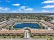 Aerial view displaying the community surrounding a scenic lake, complete with a pool area and manicured landscaping at 6400 46Th N Ave # 61, Kenneth City, FL 33709