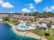 Aerial view showcases a community pool and cabana next to a serene lake at 6400 46Th N Ave # 61, Kenneth City, FL 33709