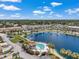 A high angle aerial view showcases the pool area next to the lake and lush landscaping within the community at 6400 46Th N Ave # 61, Kenneth City, FL 33709