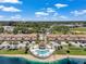 Beautiful aerial view of community, highlighting the pool and well maintained exteriors on a sunny day at 6400 46Th N Ave # 61, Kenneth City, FL 33709