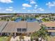 Aerial view of townhomes with a lake, community pool, and lush landscaping at 6400 46Th N Ave # 61, Kenneth City, FL 33709