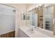 Bathroom featuring white cabinets, vanity and sink, and walk-in shower with glass door at 6400 46Th N Ave # 61, Kenneth City, FL 33709