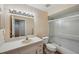 Bathroom featuring a single sink vanity, a large mirror and shower-tub combo at 6400 46Th N Ave # 61, Kenneth City, FL 33709