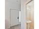 The entry has a half bath, with tile floors, pedestal sink and neutral paint, all adjacent to front door at 6400 46Th N Ave # 61, Kenneth City, FL 33709