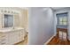 Bathroom with a single sink vanity and a view to the hallway and bedroom at 6400 46Th N Ave # 61, Kenneth City, FL 33709
