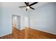 Spacious bedroom with wood floors and two doorways leading to other rooms at 6400 46Th N Ave # 61, Kenneth City, FL 33709