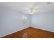 Bright bedroom with wood floors, ceiling fan, and window with plantation shutters at 6400 46Th N Ave # 61, Kenneth City, FL 33709