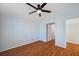 Bedroom with wood floors features a closet and an open doorway at 6400 46Th N Ave # 61, Kenneth City, FL 33709