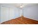 Bedroom boasts wood floors, a ceiling fan, and a double-door closet at 6400 46Th N Ave # 61, Kenneth City, FL 33709