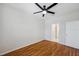 Bedroom featuring wood floors, ceiling fan, and an ensuite bathroom at 6400 46Th N Ave # 61, Kenneth City, FL 33709