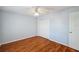 Bedroom featuring wood floors, a ceiling fan, and a double-door closet at 6400 46Th N Ave # 61, Kenneth City, FL 33709