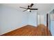Bedroom featuring wood flooring, a ceiling fan, and two entry doors at 6400 46Th N Ave # 61, Kenneth City, FL 33709